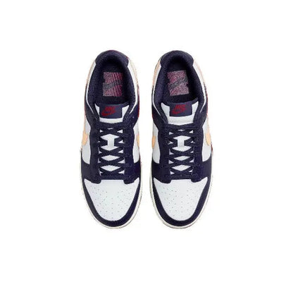 Pair of low-top sneakers seen from above with white toe panels and navy uppers
