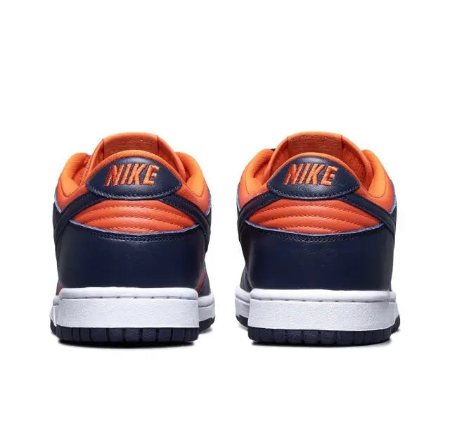 Nike Dunk Low sneakers, heel view: navy uppers with orange collar and white sole