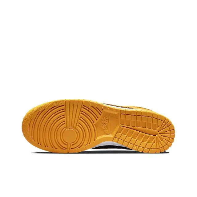 Low-top sneakers outsole view, textured yellow rubber tread with white midsole edge