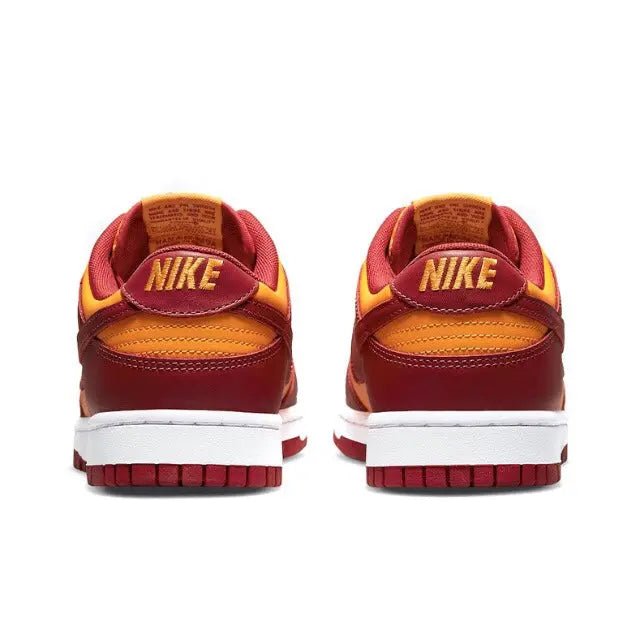 Low-top sneakers heel with Nike branding, burgundy and gold panels, white sole