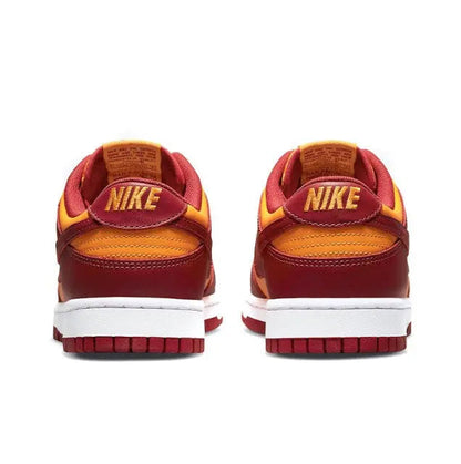 Low-top sneakers heel with Nike branding, burgundy and gold panels, white sole