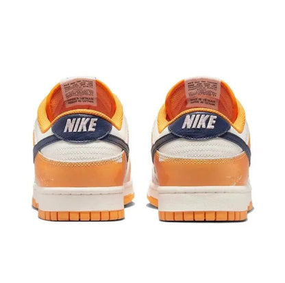 Low-top sneakers heel view with Nike branding, sail leather and orange trim