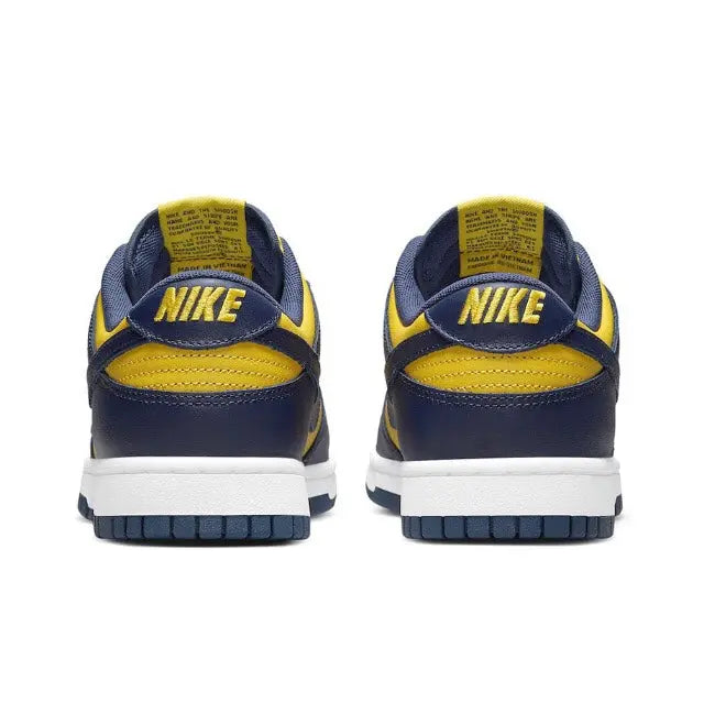 Low-top sneakers heels in navy with yellow NIKE branding and white midsole