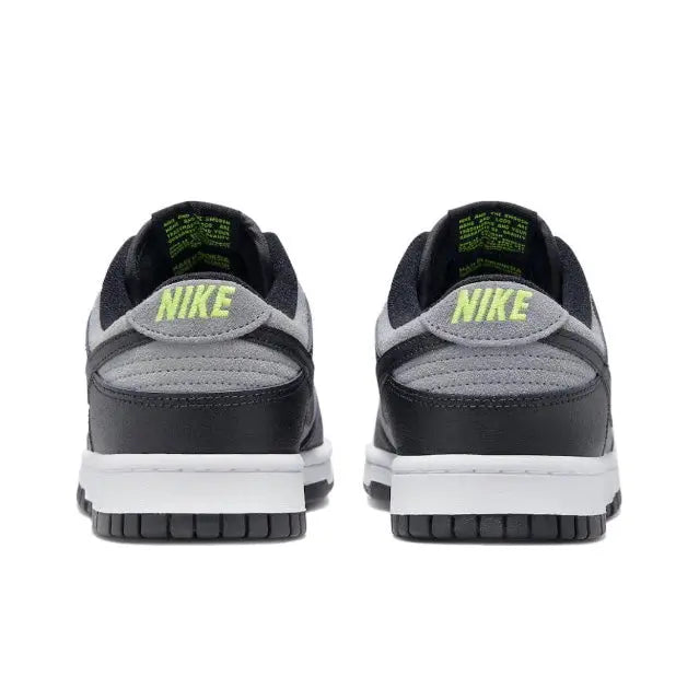 Low-top sneakers heel view in black and gray with green Nike branding