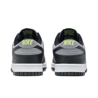 Low-top sneakers heel view in black and gray with green Nike branding