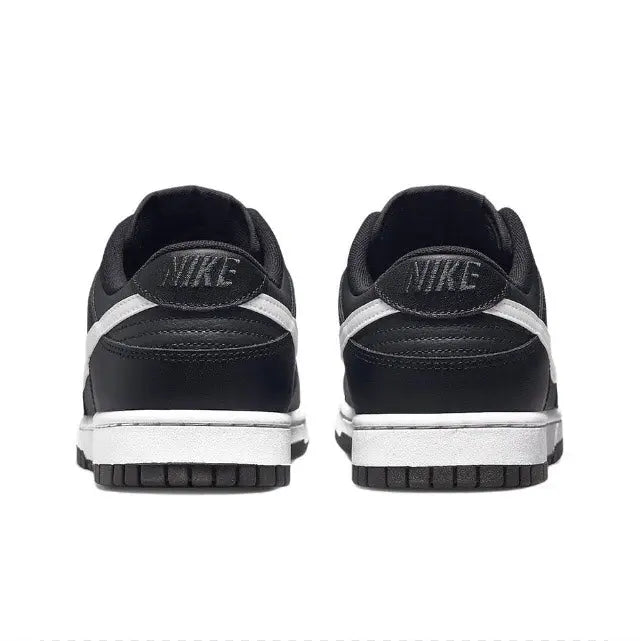 Low-top sneaker heel view in black with NIKE branding and white midsole stripe