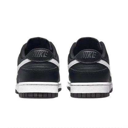 Low-top sneaker heel view in black with NIKE branding and white midsole stripe
