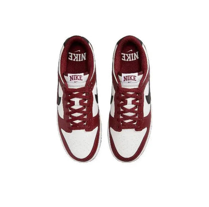 Low-top sneakers with burgundy and white uppers and lace-up eyelets