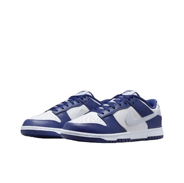 Low-top sneakers with deep blue suede panels and white leather overlays