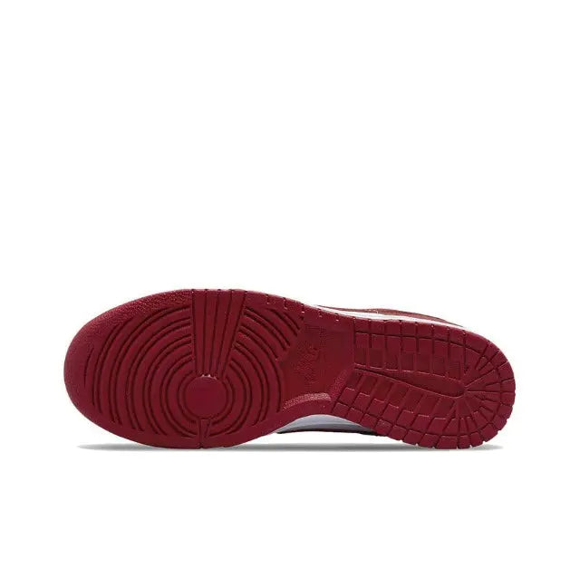 Nike Dunk Low outsole view with red rubber tread and circular traction pattern