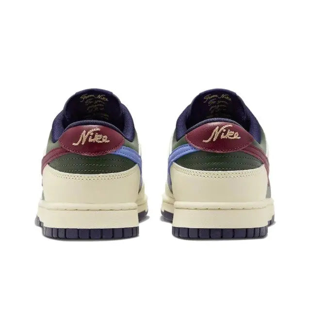Low-top sneakers heel view: navy back, cream midsole, burgundy collar, Nike-branded tab.
