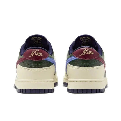 Low-top sneakers heel view: navy back, cream midsole, burgundy collar, Nike-branded tab.