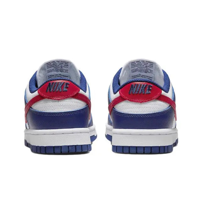 Low-top sneaker heel view, blue and white leather with red heel tab and Nike branding.