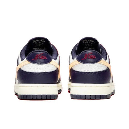 Low-top sneakers heel view in navy upper with beige trim and white midsole