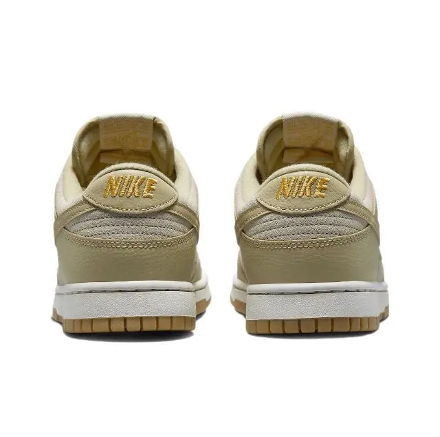 Nike Dunk Low sneakers heel view in light beige with NIKE logo branding