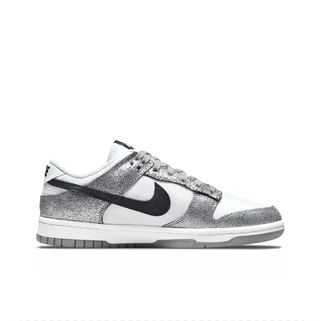 Low-top sneaker side profile, white upper with silver speckle and black swoosh
