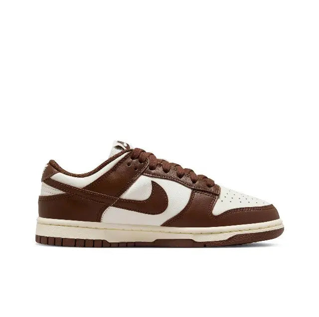 Nike Dunk Low sneakers, angled side view, brown leather and white with cream sole