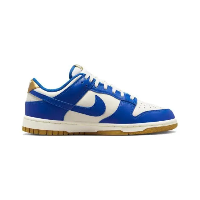 Low-top sneakers side view with blue and sail panels, blue swoosh, lace-up