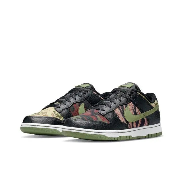 Nike Dunk Low sneakers angled view, black base with camo panels and green Swoosh