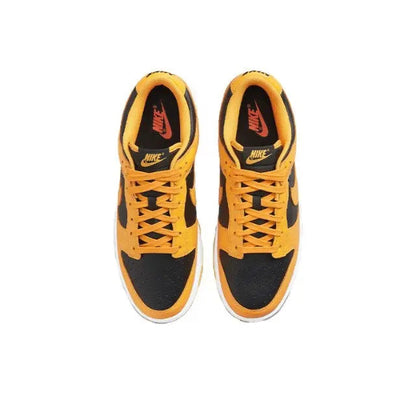 Low-top sneakers front view, orange laces over black toe panels and Nike Swoosh