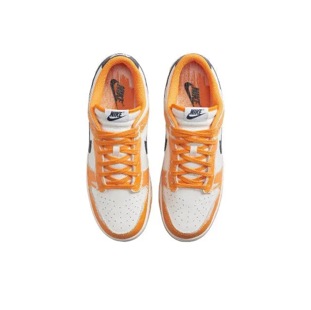 Low-top sneakers tongue and lace view, sail uppers with orange laces and navy accents