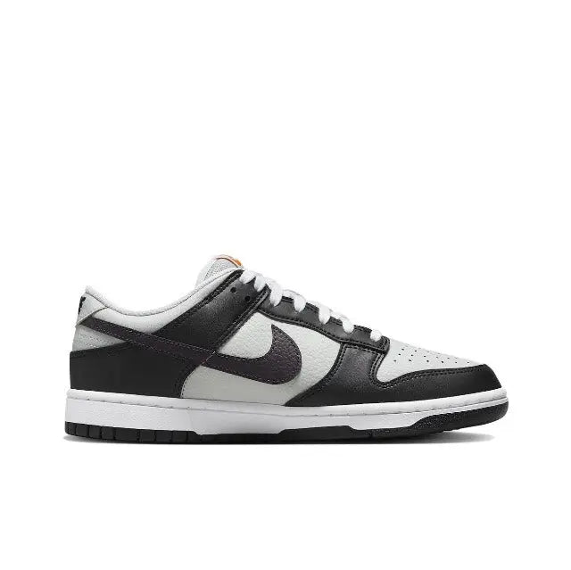 Low-top sneaker, white toe box with black panels and orange heel accent