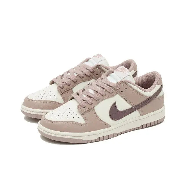 Nike Dunk Low low-top sneakers, angled view, off-white panels and taupe overlays with mauve Swoosh