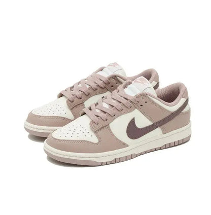 Nike Dunk Low low-top sneakers, angled view, off-white panels and taupe overlays with mauve Swoosh