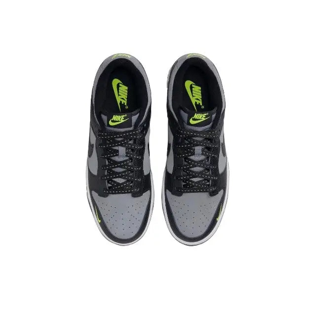 Low-top sneakers from above, black laces and lime-green Nike logos