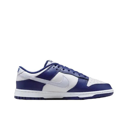 Low-top sneakers side view with white leather, deep blue overlays, and laces