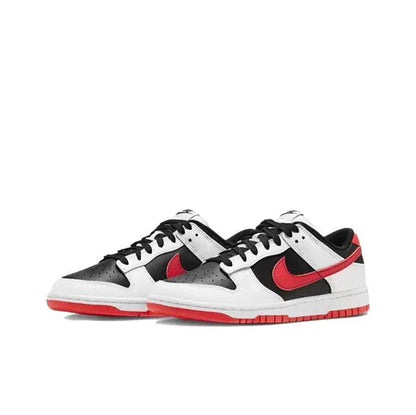 Low-top sneaker angled side view with white leather, black panels, and red swoosh