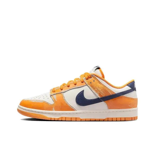 Low-top sneaker quarter view, orange toe and panels with navy Swoosh and sail leather