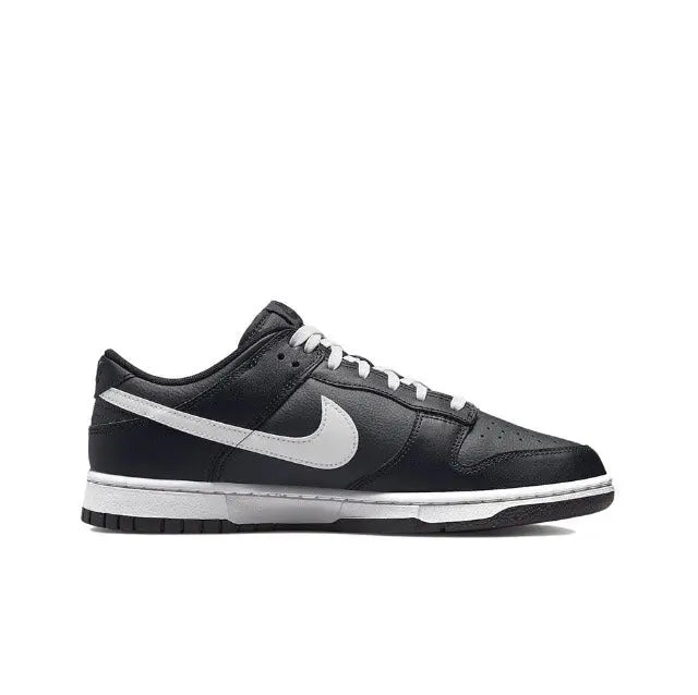 Low-top sneaker side view in black with white Swoosh and lace eyelets