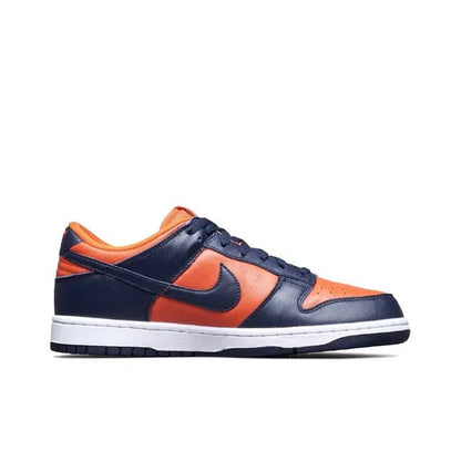 Nike Dunk Low sneakers, profile view: navy and orange low-top with white midsole