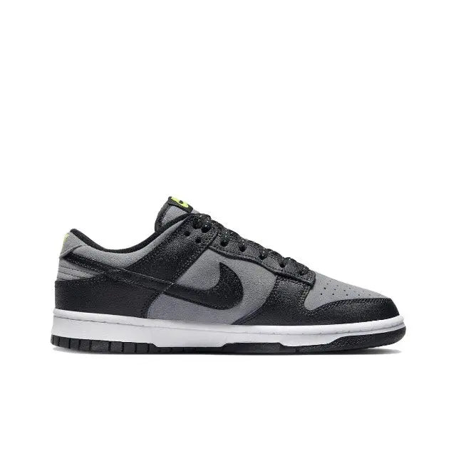 Low-top sneakers side profile, black upper with gray panels and green Swoosh