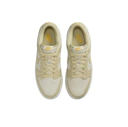Nike Dunk Low sneakers top view in light beige with laces and yellow tongue lining