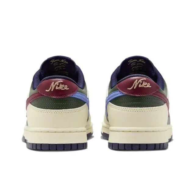 Low-top sneakers rear view: navy heel, cream base, burgundy collar with Nike logo.