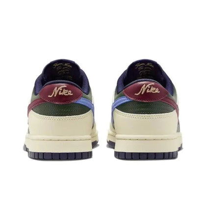 Low-top sneakers rear view: navy heel, cream base, burgundy collar with Nike logo.