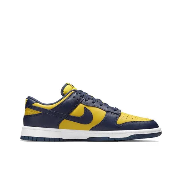 Low-top sneakers side view, navy suede with maize panels and yellow swoosh