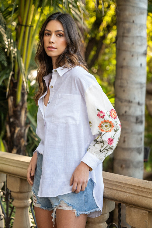 White cotton button-up shirt with floral embroidered sleeves