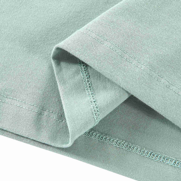 Light blue T-shirt sleeve cuff with stitched hem and lace-like trim