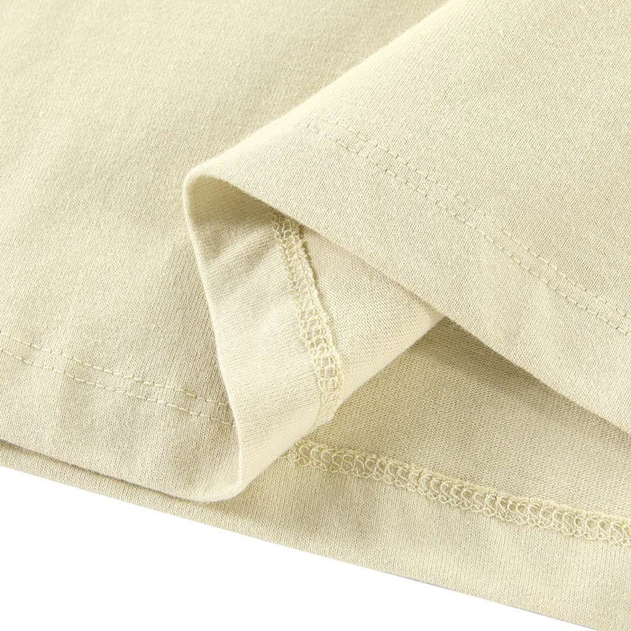 Light yellow T-shirt sleeve cuff with stitched hem