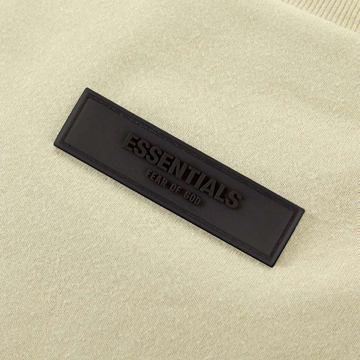 Light yellow T-shirt with black 'ESSENTIALS' woven label