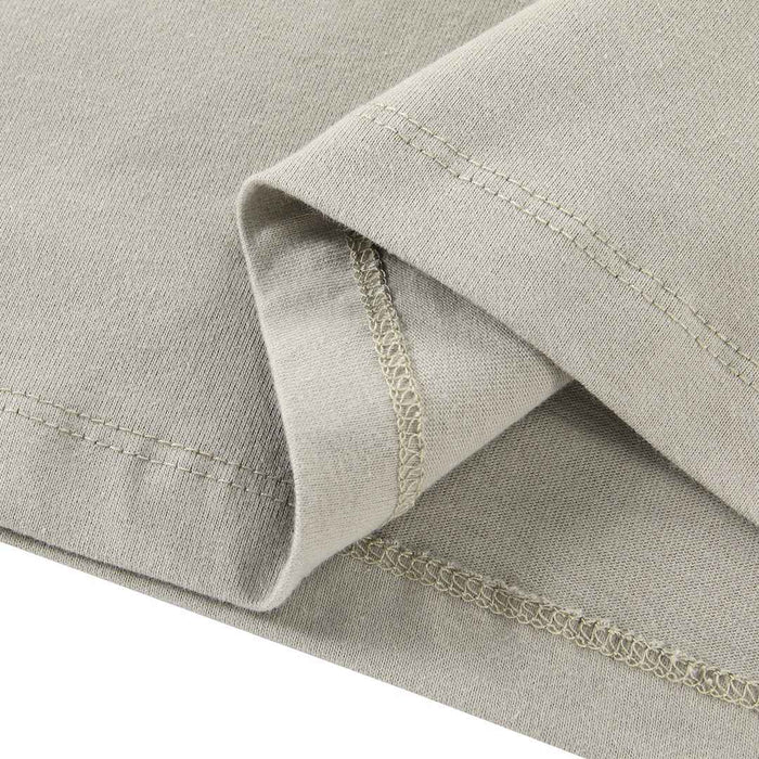 Essentials T-shirt cuff detail with layered fabric seams in light gray