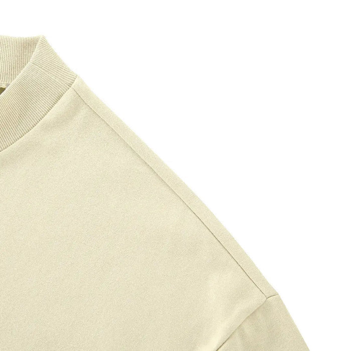 Light yellow T-shirt side panel with stitched seam