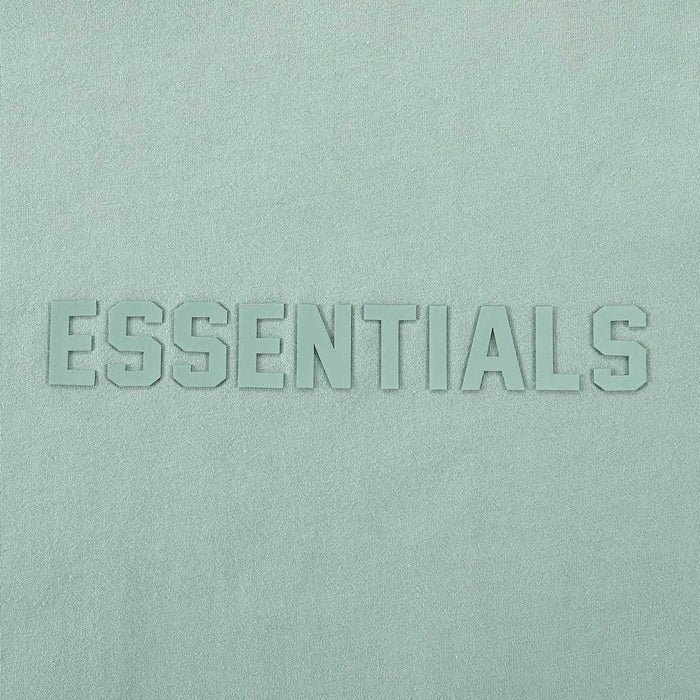 Light blue T-shirt with raised ESSENTIALS wordmark logo