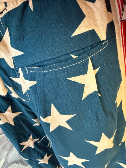 Blue flag print drawstring pants with cream stars and stitched pocket detail