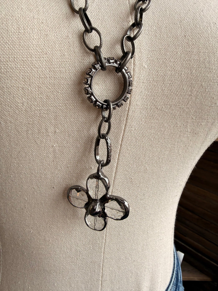 Floral crystal pendant necklace with flower-shaped charm and dangling chain links