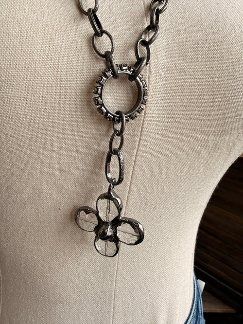 Floral crystal pendant necklace with flower-shaped charm and dangling chain links