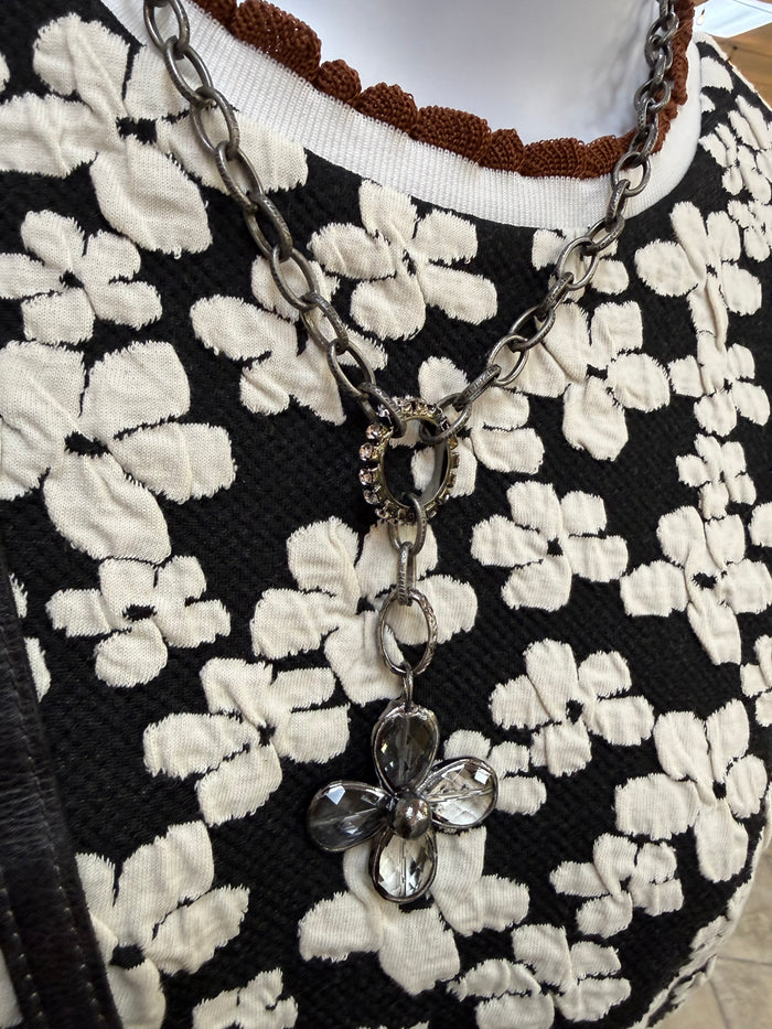 Black floral embossed knit shirt with crew neck and ribbed neckline trim